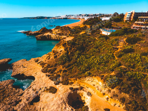 Preview: Rocky Coastline With Some Houses On The Top