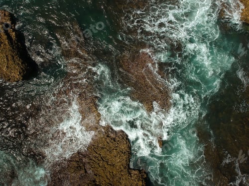Preview: Aerial View Of Sea Waves Crash On The Rocks In The Coastline