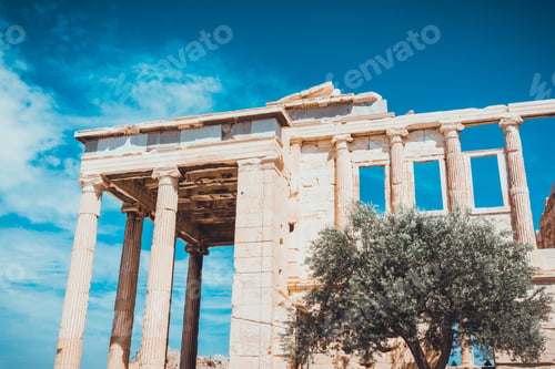 Preview: Scenic View Of Beautiful Greek Monument Besides One Scraggly Tree On A Clear Day