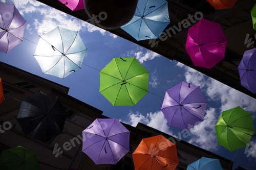 Preview: A Series Of Umbrellas Of Different Colors Hung With A Steel Wire