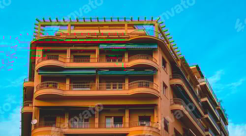 Preview: Majestic Orange Apartment Corner Building With Clean Blue Sky