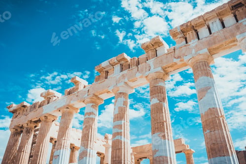 Preview: Old Ruined Doric Stone Columns On A Greek Temple Against A Cloudy Blue Sky In A Travel And Tourism