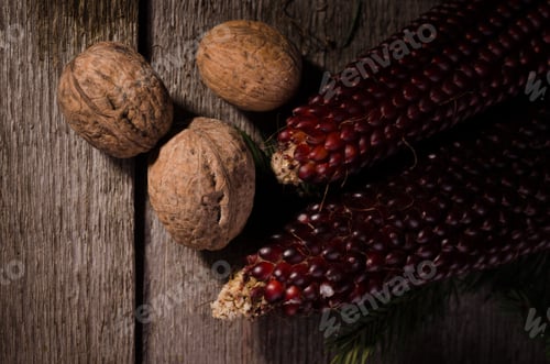 Preview: Autumnal Rural Frame With Plenty Of Dry Walnuts And Corns On An Old Wooden Background.