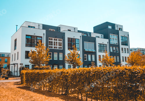 Preview: Real Estate Picture Of Townhouses With Bushes In The Foreground