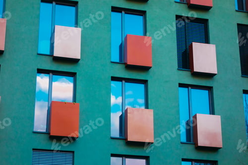 Preview: Green Facaded Building With Colorful Red And Orange Balcony