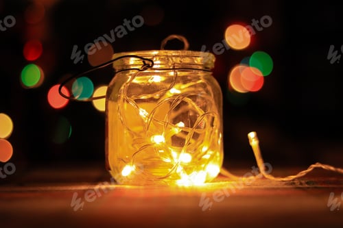 Preview: Transparent Jar With Led Lights Inside And Bokeh Lights In Background. Home Decoration