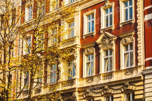 Preview: Detailed View Of Red Facade With Yellow Tree