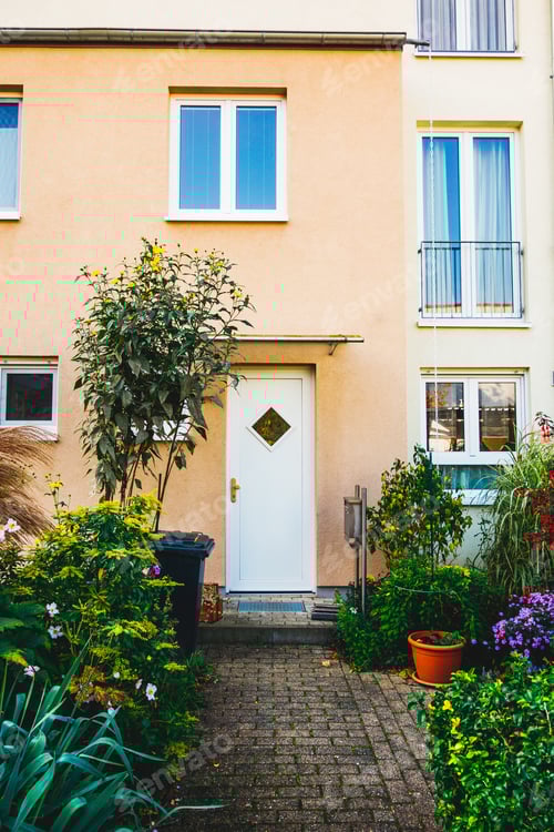 Preview: Orange Townhouse Facade With White Door And Blue Windows