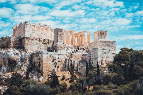 Preview: Overall View Of Acropolis Of Athens On Tree Covered Hill Under Blue Sky With White Clouds