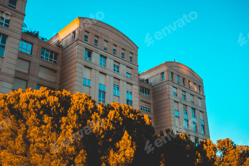 Preview: A Modern, Architectural Apartment Building Complex With A Blue Sky Background.