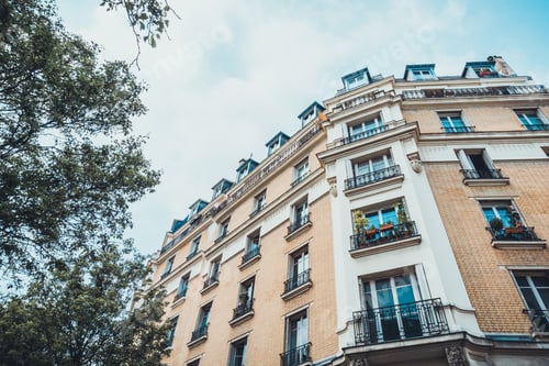 Preview: Extreme Low Angle View On Brick And Stone Apartment Building With Little Gates In Front Of Windows
