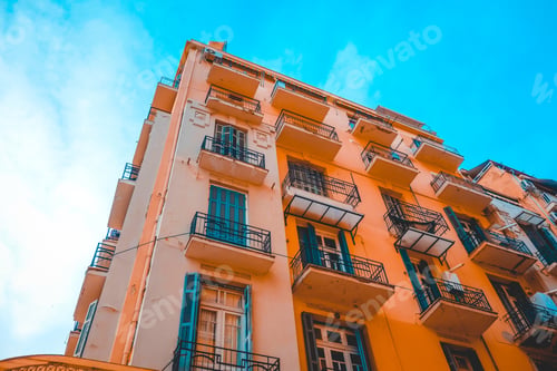 Preview: Low Angle View Of Orange Apartment Complex At Thessaloniki