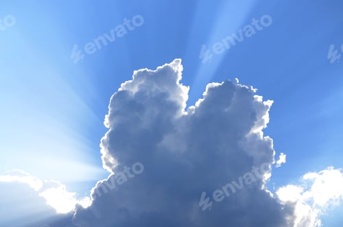 Preview: Sun Rays Look Out Behind Of Cumulus Clouds In A Blue Sky. Summer Sunny Background