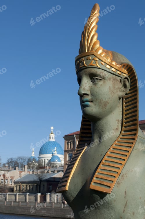 Preview: The Head Of The Ancient Sphinx In The Background The Dome Of Trinity Cathedral. St. Petersburg