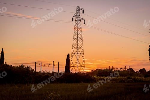 Preview: Power Pylons And Wires With Sunset In Background
