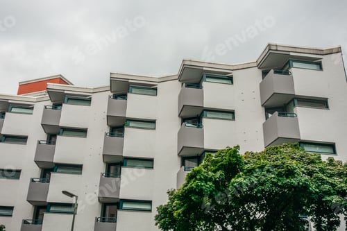 Preview: White Apartment Building With Grey Balcony