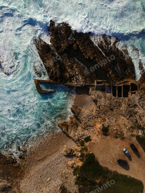 Preview: Aerial View Of Waves Crashing Against The Coastline,With Tree Cars Parked Near The Sea. Seascape