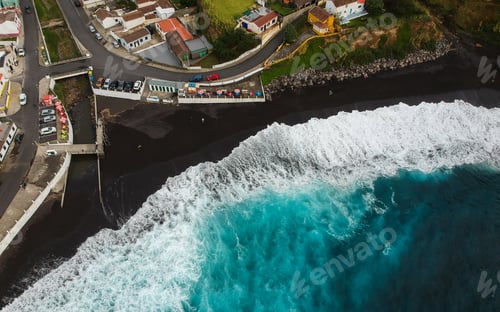 Preview: Aerial Top View Of Sea Waves Hitting A Beach With Black Volcanic Sand With Turquoise Sea Water