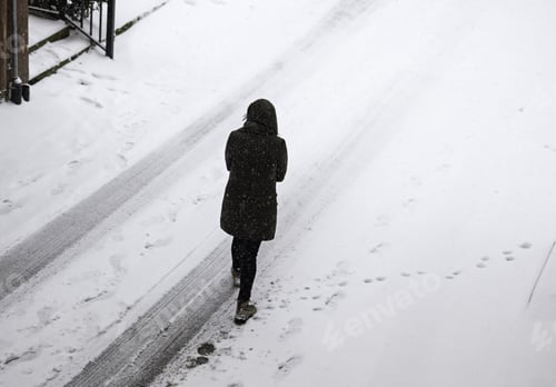 Preview: Woman Walking In Snow On Urban Street, Winter Season