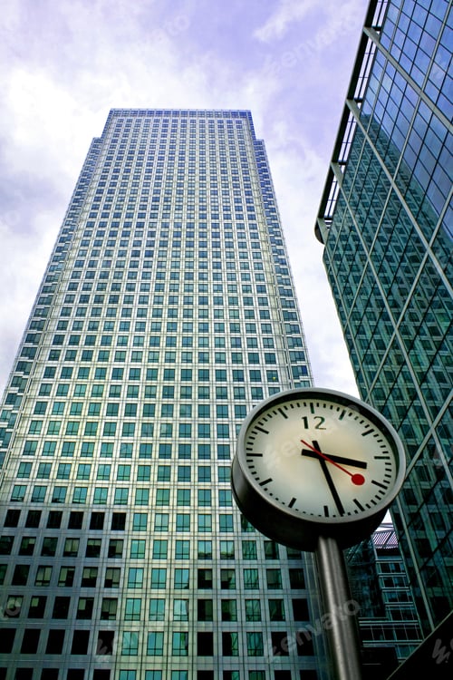 Preview: Big Clock In Front Of Two Business Buildings
