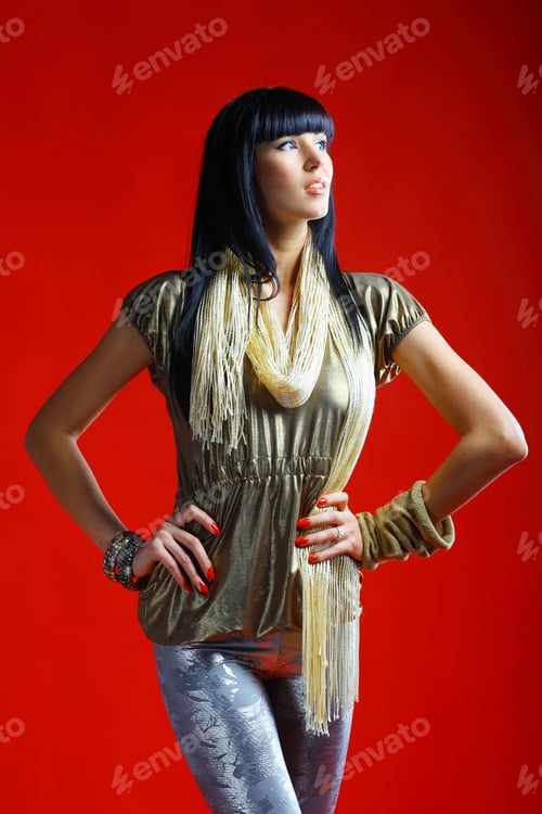 Preview: Portrait Of A Sexy Female Model Posing Against Red Background