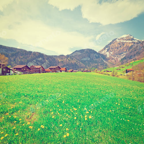 Preview: Small Swiss Town Surrounded By Meadows On The Background Of Snow-Capped Alps, Retro Effect