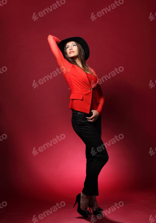Preview: Beautiful Woman In A Hat On A Red Background. Flirty Look. Game Emotions. Beautiful Figure