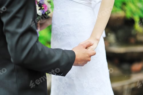 Preview: Bride And Groom Holding Each Other By The Hand