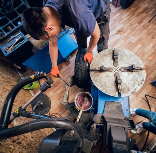 Preview: Professional Car Mechanic Replace Tire On Wheel. Auto Repair Service.