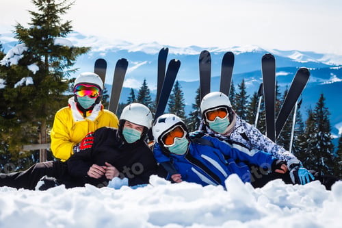 Preview: Family Wearing A Medical Mask During Covid-19 Coronavirus On A Snowy Mountain At A Ski Resort