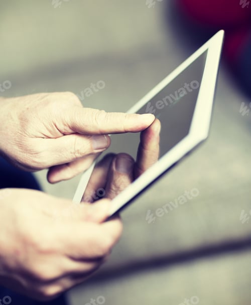 Preview: An Elderly Man Browsing The Internet With A Tablet In A Living Room And Sitting In A Sofa. Image