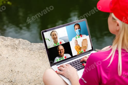 Preview: Cropped Image Of Young Woman Using Laptop For Video Conference At Home