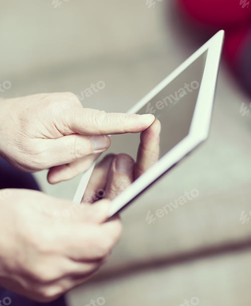 Preview: An Elderly Man Browsing The Internet With A Tablet In A Living Room And Sitting In A Sofa. Image