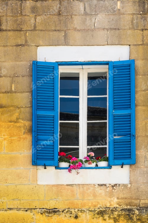 Preview: Building With Traditional Maltese Window Decorated With Fresh Flowers In Valletta.