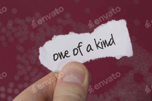 Preview: A Man Is Holding A Piece Of Paper Saying 'One Of A Kind'. The Paper Is White And The Background Is