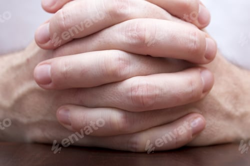 Preview: Man Is Holding Hands Together And Praying.