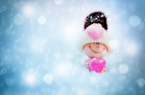 Preview: Valentine Toy In Knitted Hat With Heart Against A Background Of Snow,.The Metaphor Of Love