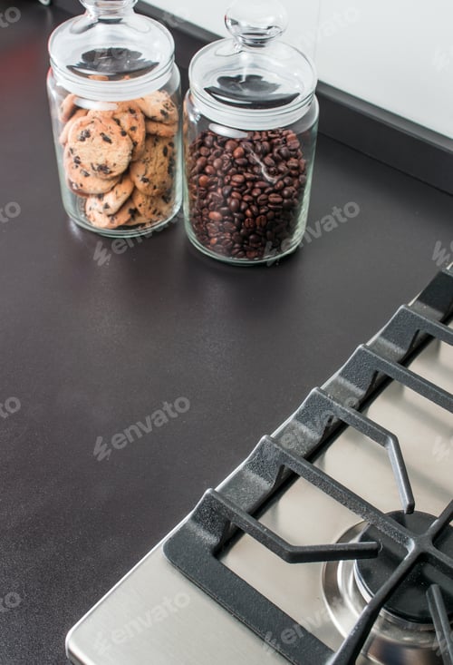 Preview: Jars Of Coffee Beans And Cookies On The Kitchen Near The Stove Surface