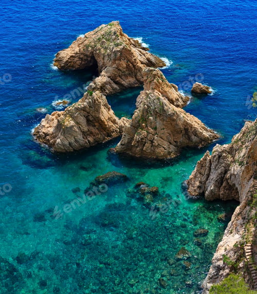 Preview: Summer Sea Rocky Coast Landscape With Green Transparent Water And Sunny Sparks (Spain). View From