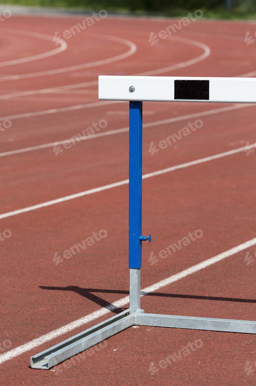 Preview: An Image Of A Training Hurdles In Sunlight On A Red Surface.