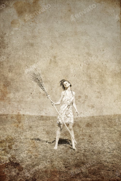 Preview: Young Red-Haired Witch At Green Grass Field With Broom. Photo In Old Image Style.