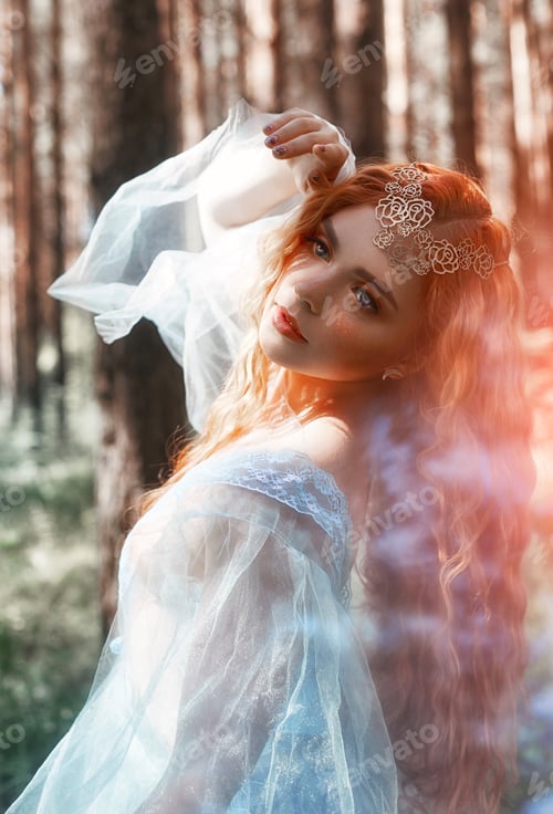 Preview: Beautiful Redhead Woman Forest Nymph In A Blue Transparent Light Dress In The Woods Spinning In