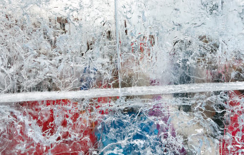 Preview: Glacial Transparent Wall Of Ice With Interesting Drawings And Patterns And Colorful Objects Behind.