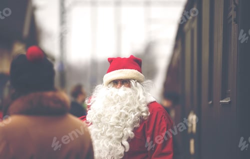 Preview: Real Santa Claus Is Standing On A Railway Station In Christmas Time. There Is An Unidentified Man