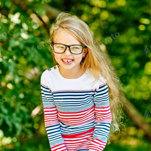 Preview: Beautiful Smiling Little Girl In Glasses In Summer Park - Close Up
