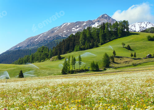 Preview: Irrigation Water Spouts In Summer Alps Mountain (Italy). Blue Sky With Cloud.
