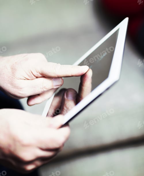 Preview: An Elderly Man Browsing The Internet With A Tablet In A Living Room And Sitting In A Sofa. Image