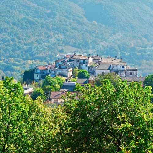 Preview: Medieval Italian City On A Hilltop Surrounded By Mountains Covered With Forests