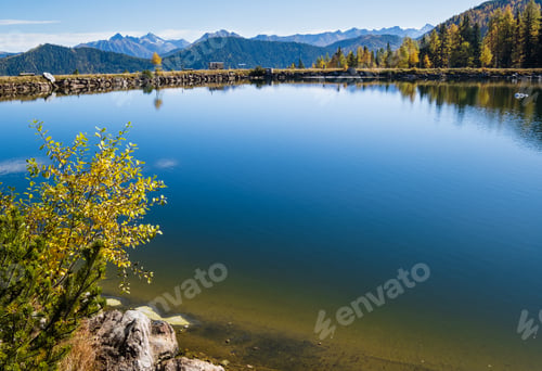 Preview: Sunny Autumn Alpine View. Peaceful Mountain Lake With Clear Transparent Water And Reflections