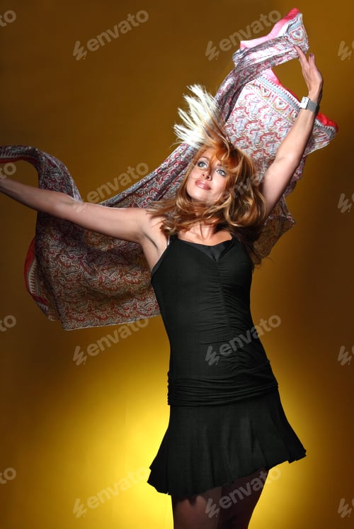 Preview: Woman Posing with Scarf Against Gold Background